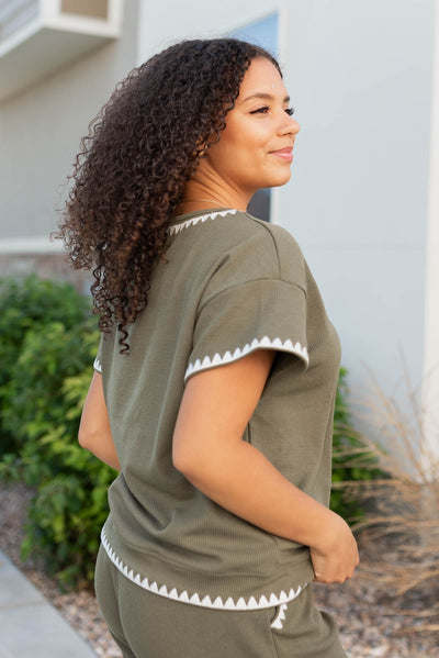 Side view of the olive embroidered top