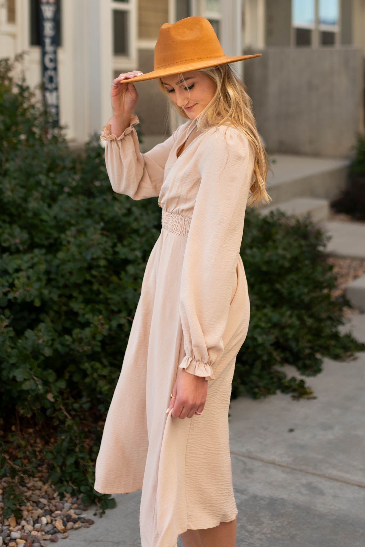 Side view of a beige v-neck dress