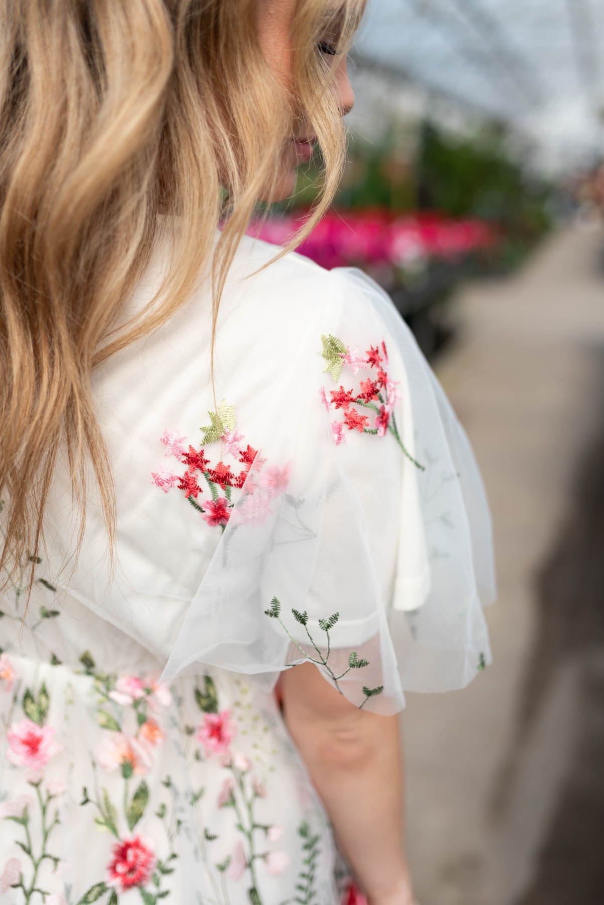 Sleeve view of the pink embroidered mesh dress