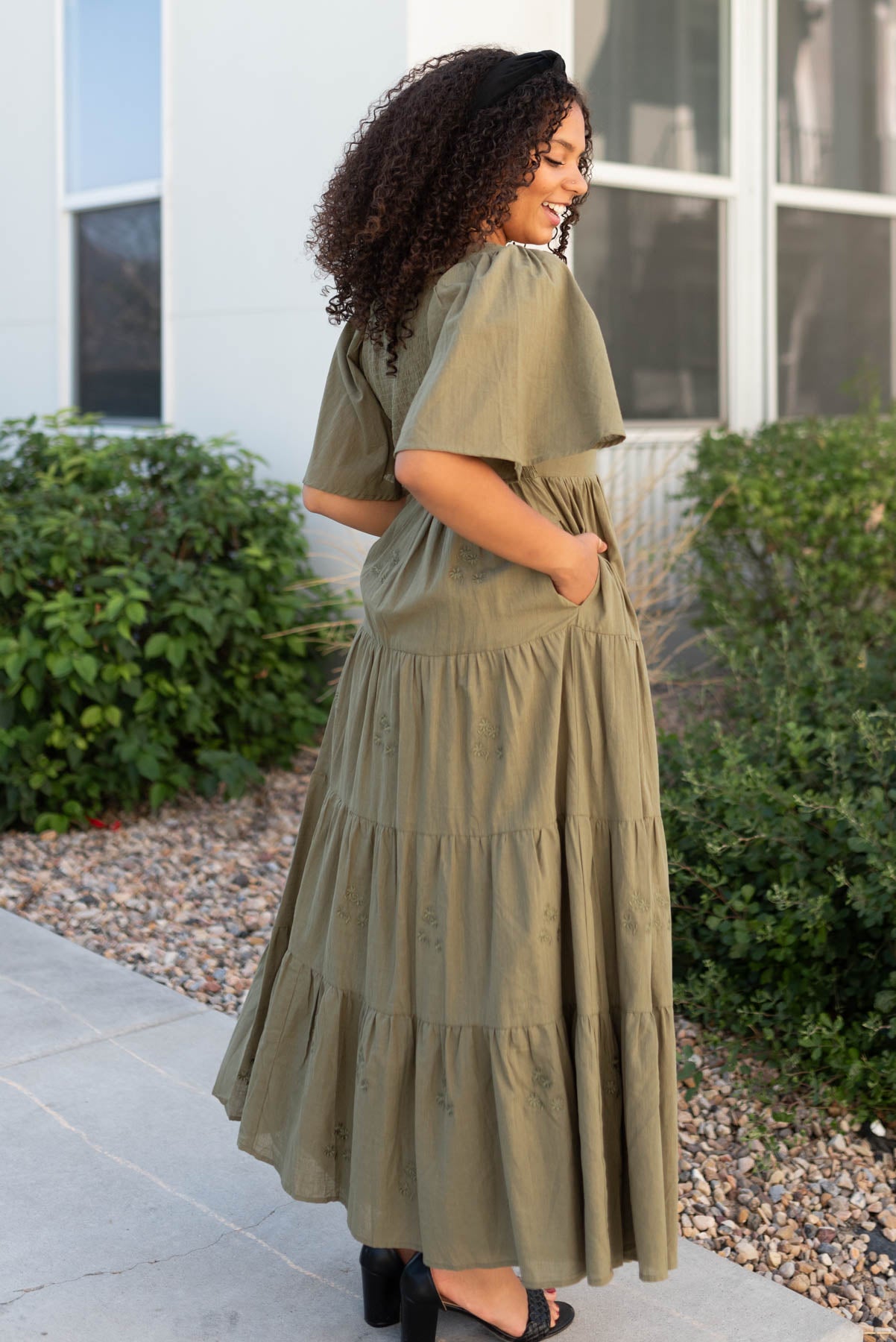 Side view of the olive floral embroidered dress with pockets