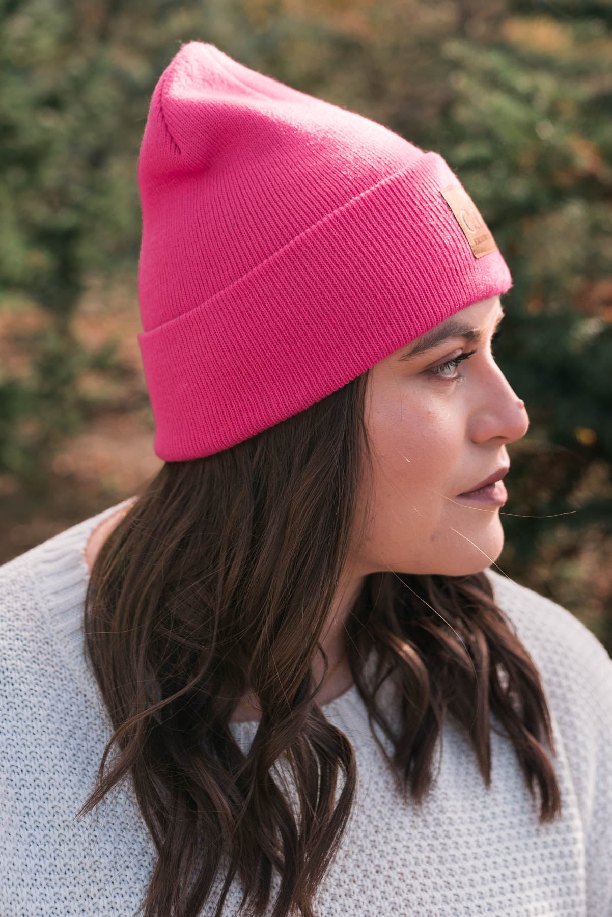 Side view of the fuchsia C.C beanie