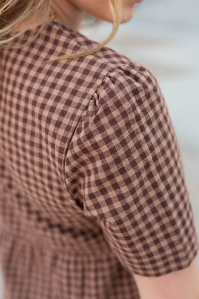 Close up of the sleeve on the brown gingham dress