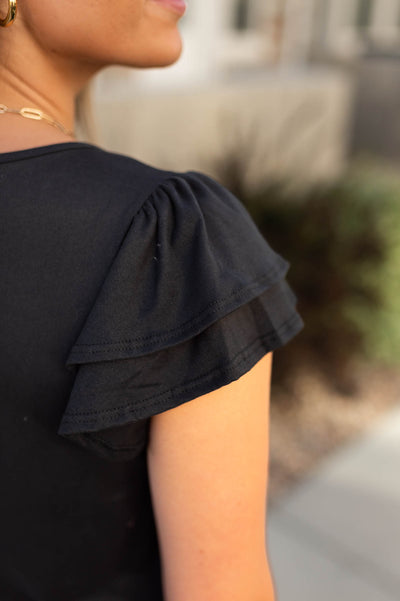 Ruffle sleeve on the Emery black top