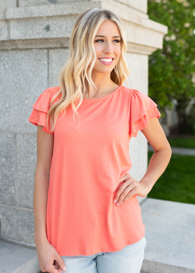 Tangerine top with ruffle sleeves