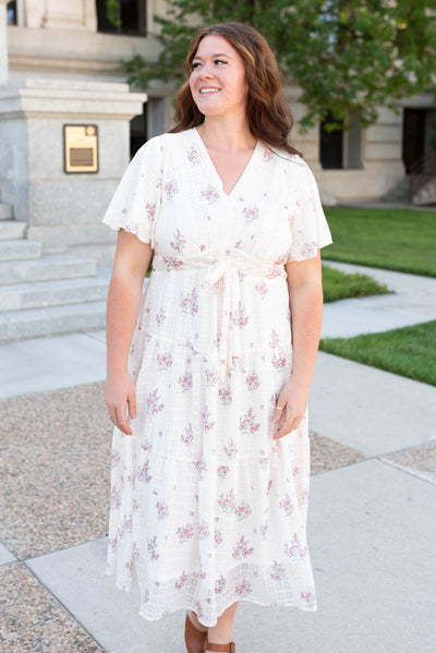 Plus size cream floral tiered dress with lace around the v-neck