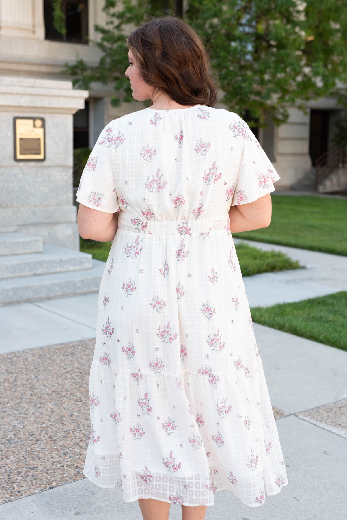 Back view of the plus size cream floral tiered dress