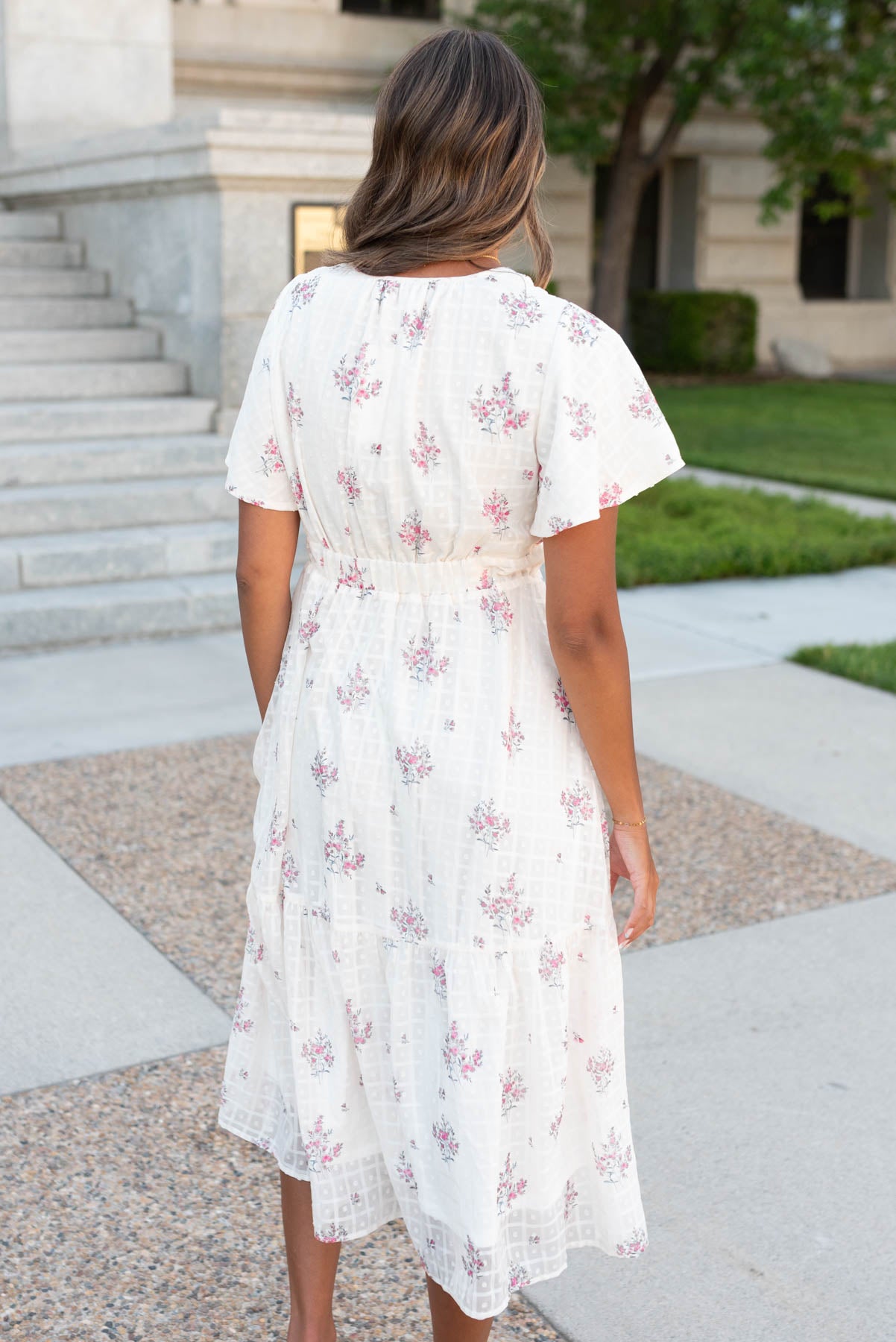 Back view of the cream floral tiered dress