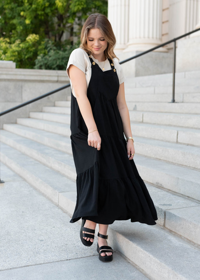 Black overall dress with tiered skirt