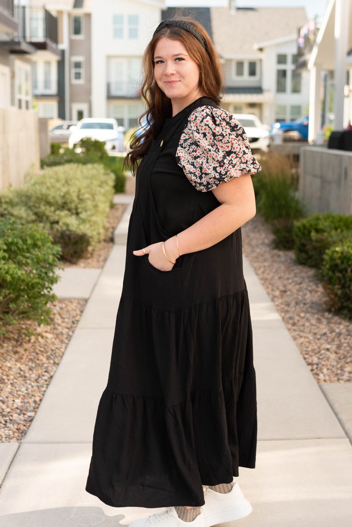 Side view of the plus size black overall dress