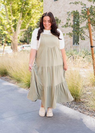 Front view of the plus size sage green overall dress with pockets