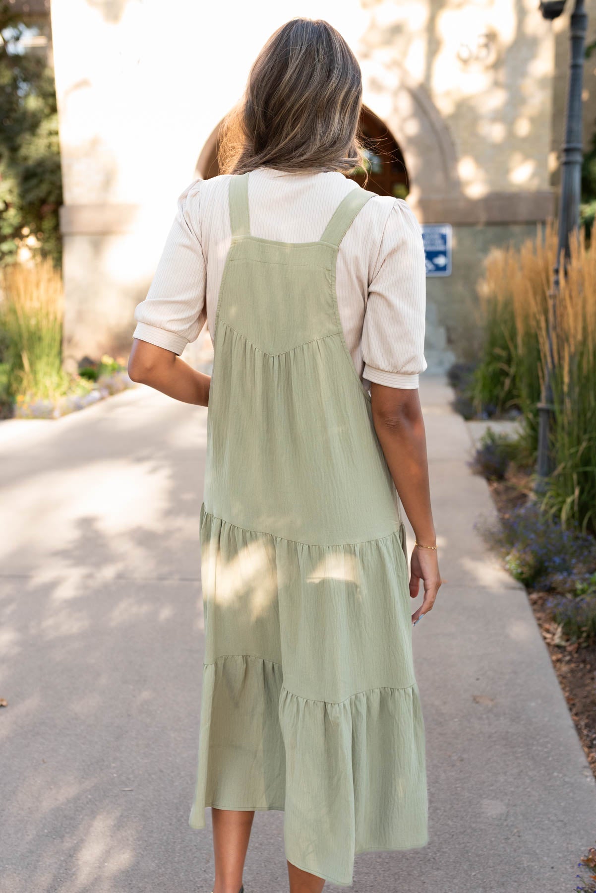 Back view of the sage green overall dress