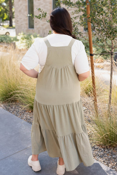 Plus size back view of the sage green overall dress