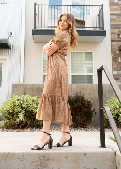 Side view of the taupe black dot dress