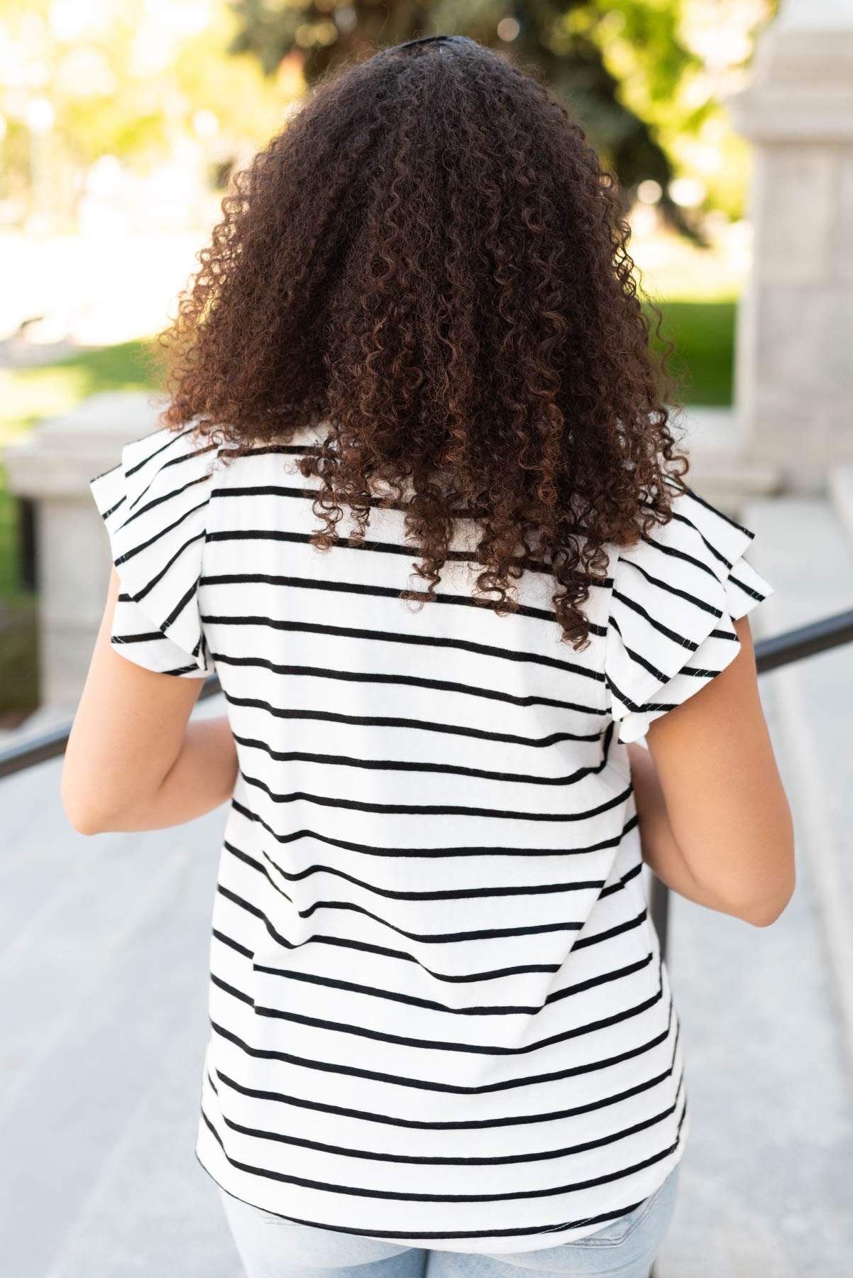 Back view of the black stripe ruffle top