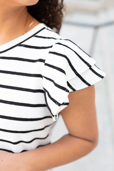 Close up of the sleeve and fabric on the black stripe ruffle top