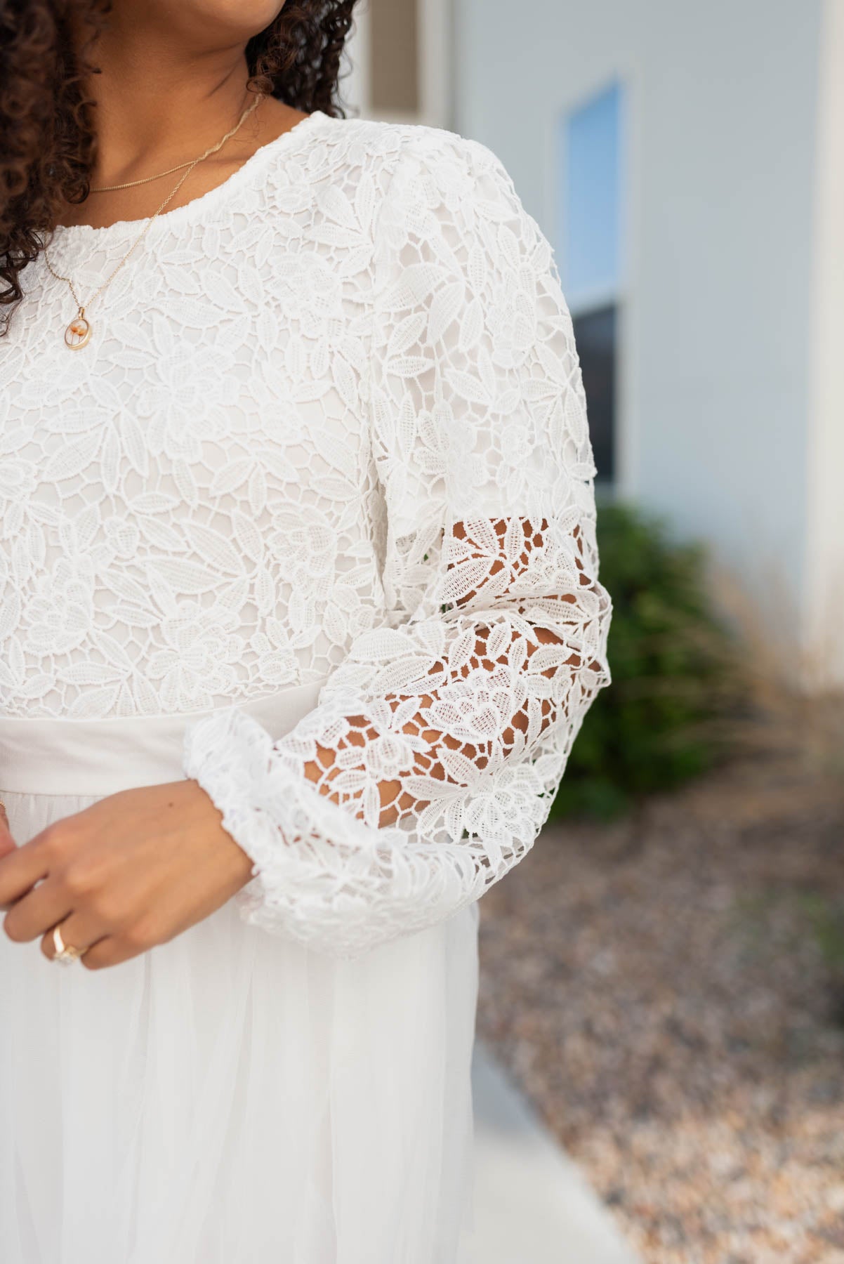 Close up of the lace and sleeve on the white lace tulle dress