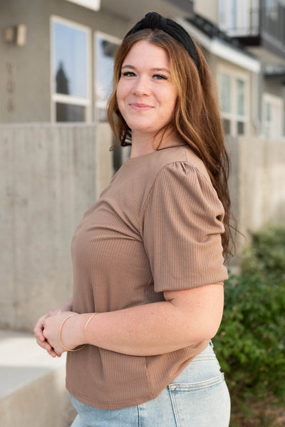 Side view of the plus size basic brown top