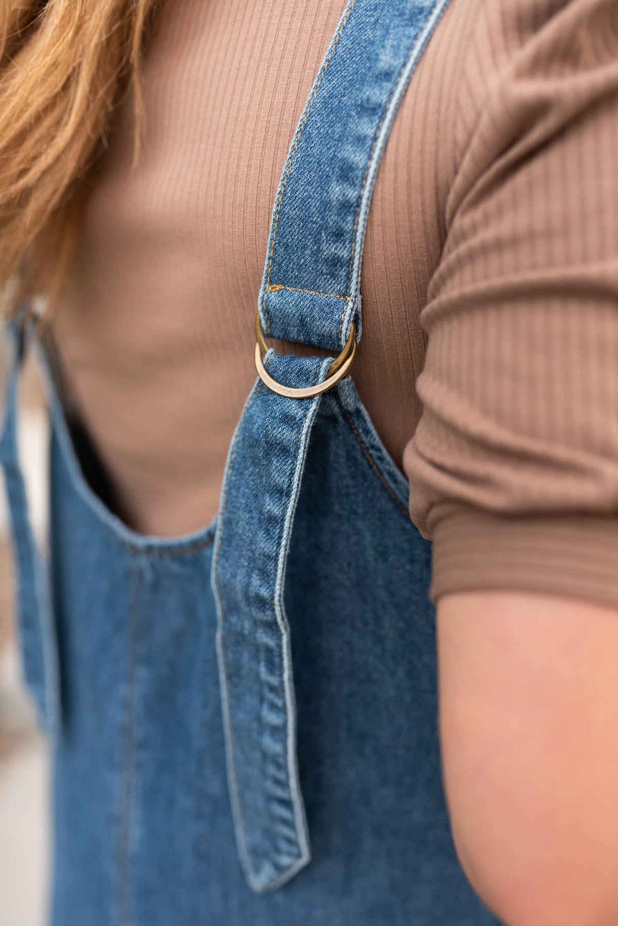 Indigo denim overall dress with adjustable straps in the back