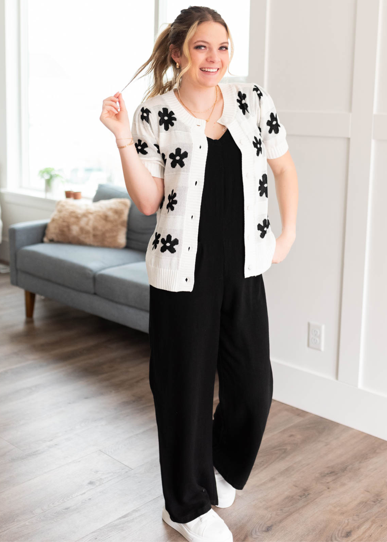 Front view of the ivory floral short sleeve sweater with black flowers