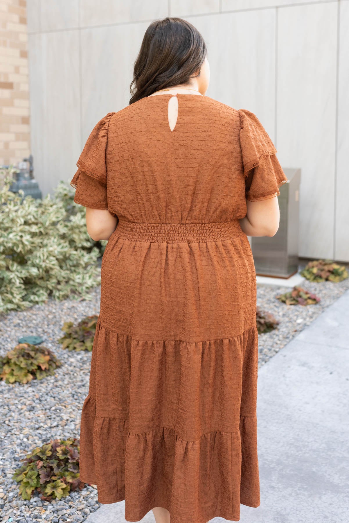 Back view of the chestnut ruffle tiered dress in plus size