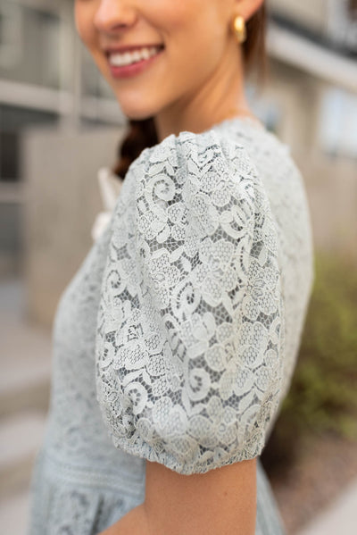 Close up of the sleeve on the sage blue lace dress