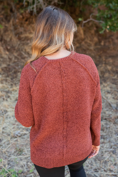 Back view of the dark rust knitted sweater