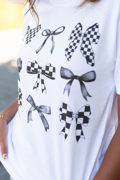 Close up of the bows on the white bow gird top