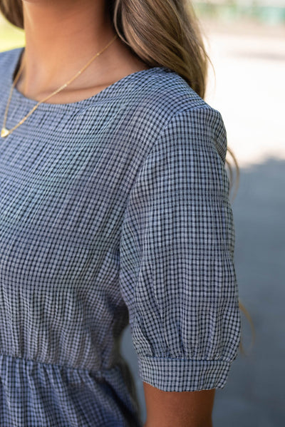 Close up of the sleeve and fabric on the charcoal gingham dress