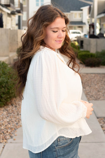 Side view of the cream long sleeve top in plus size