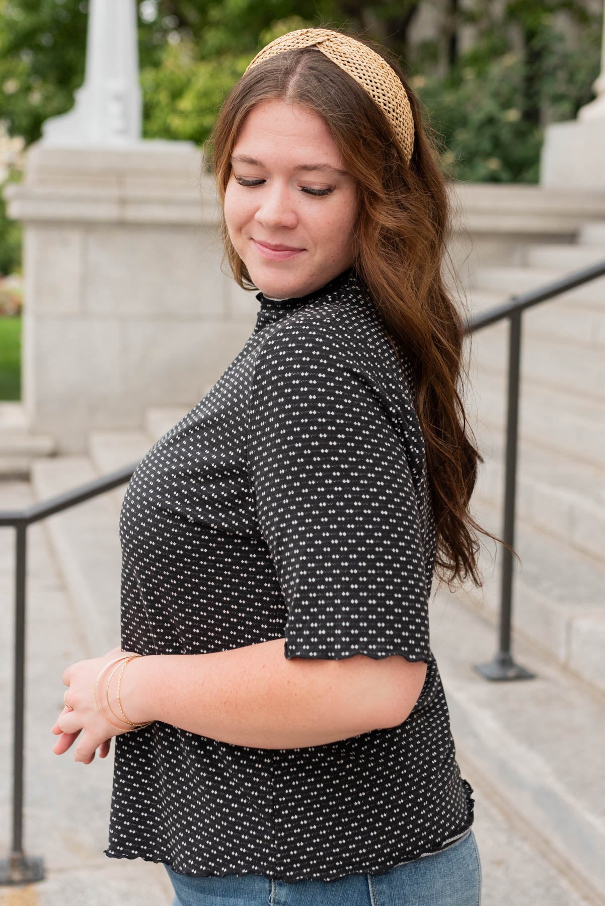 Side view of the black dot texture top in plus size