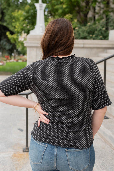 Back view of the plus size black dot texture top