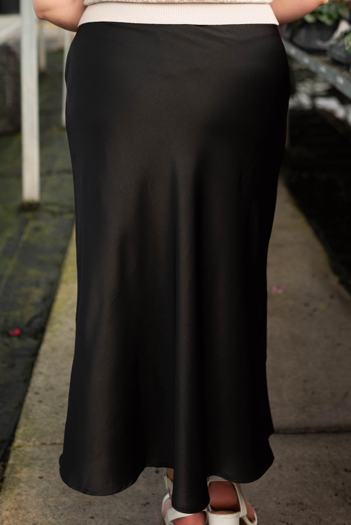 Back view of the black satin midi skirt