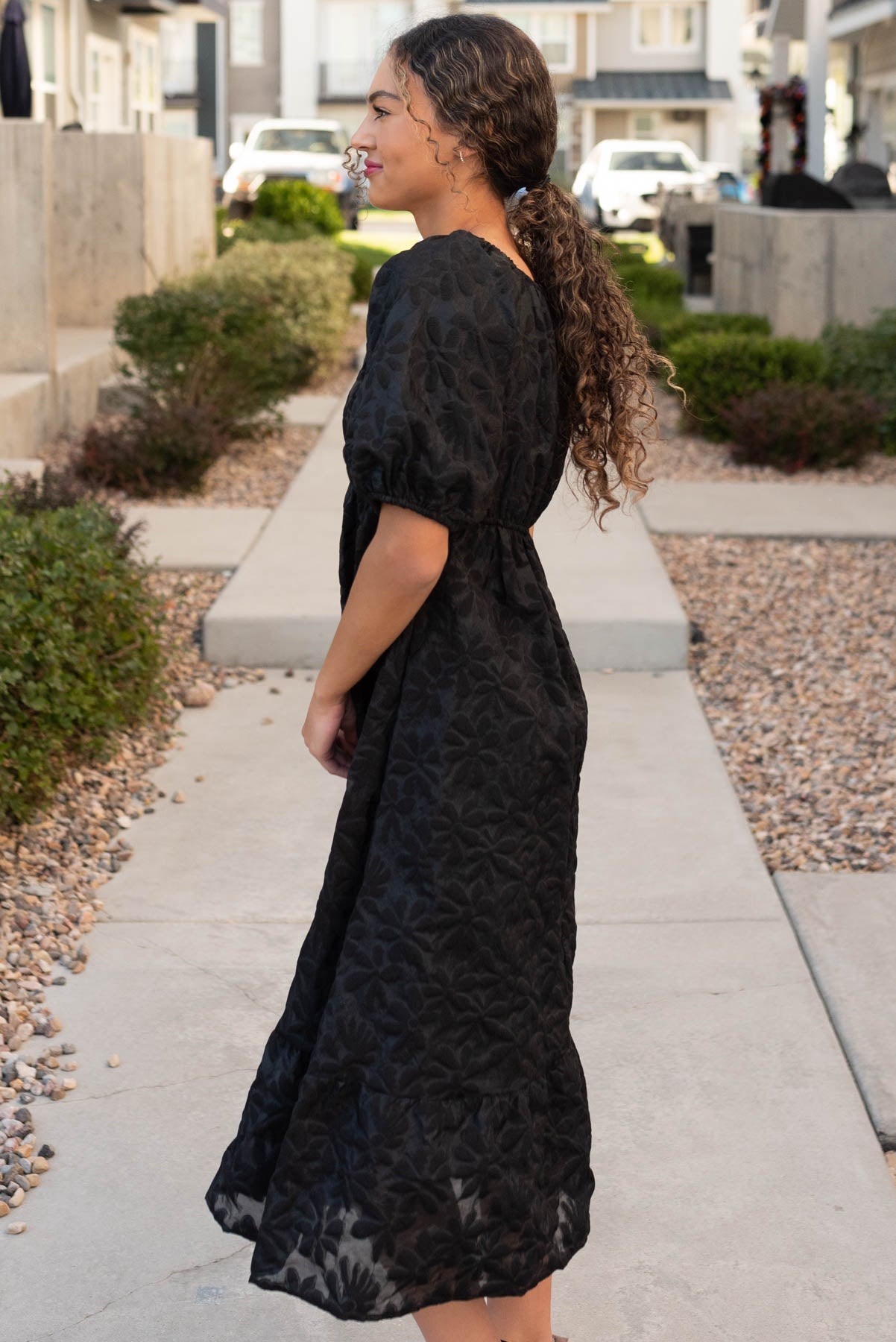 Side view of the black tiered floral dress