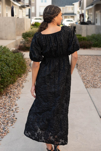 Back view of the black tiered floral dress