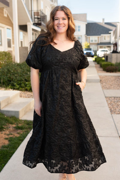 Plus size black tiered floral dress with short sleeves and sweetheart neck