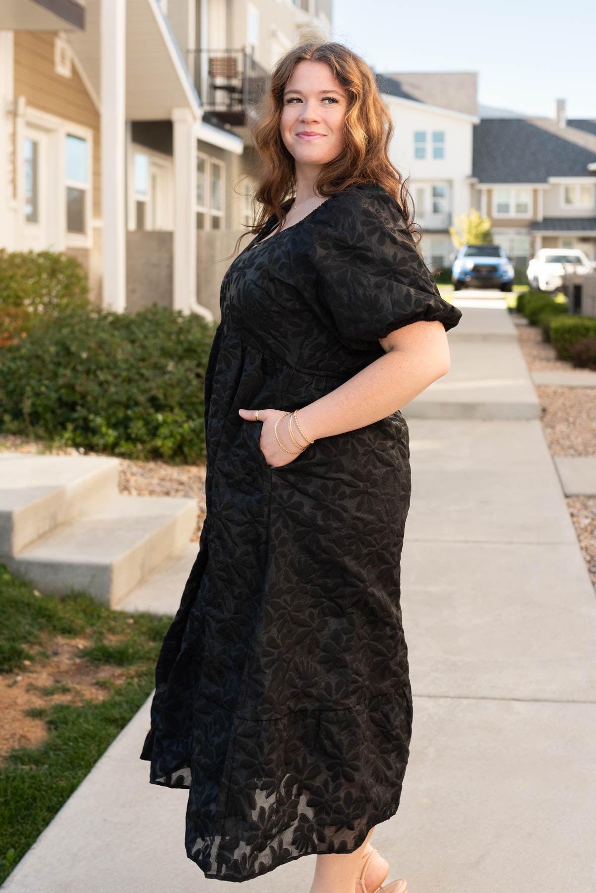 Side view of the plus size black tiered floral dress