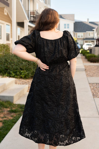 Back view of the plus size black tiered floral dress