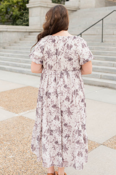 Back view of the cream floral smocked dress in plus size