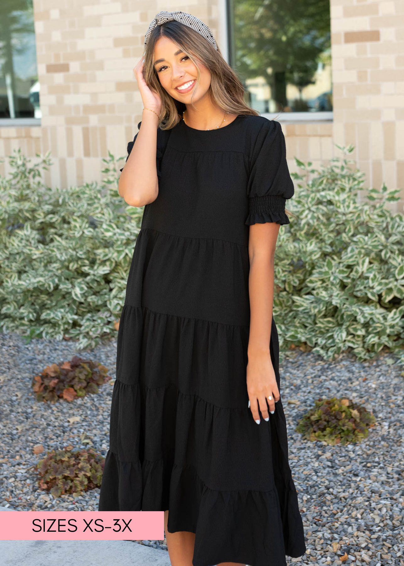 Tiered black dress with elastic cuffs