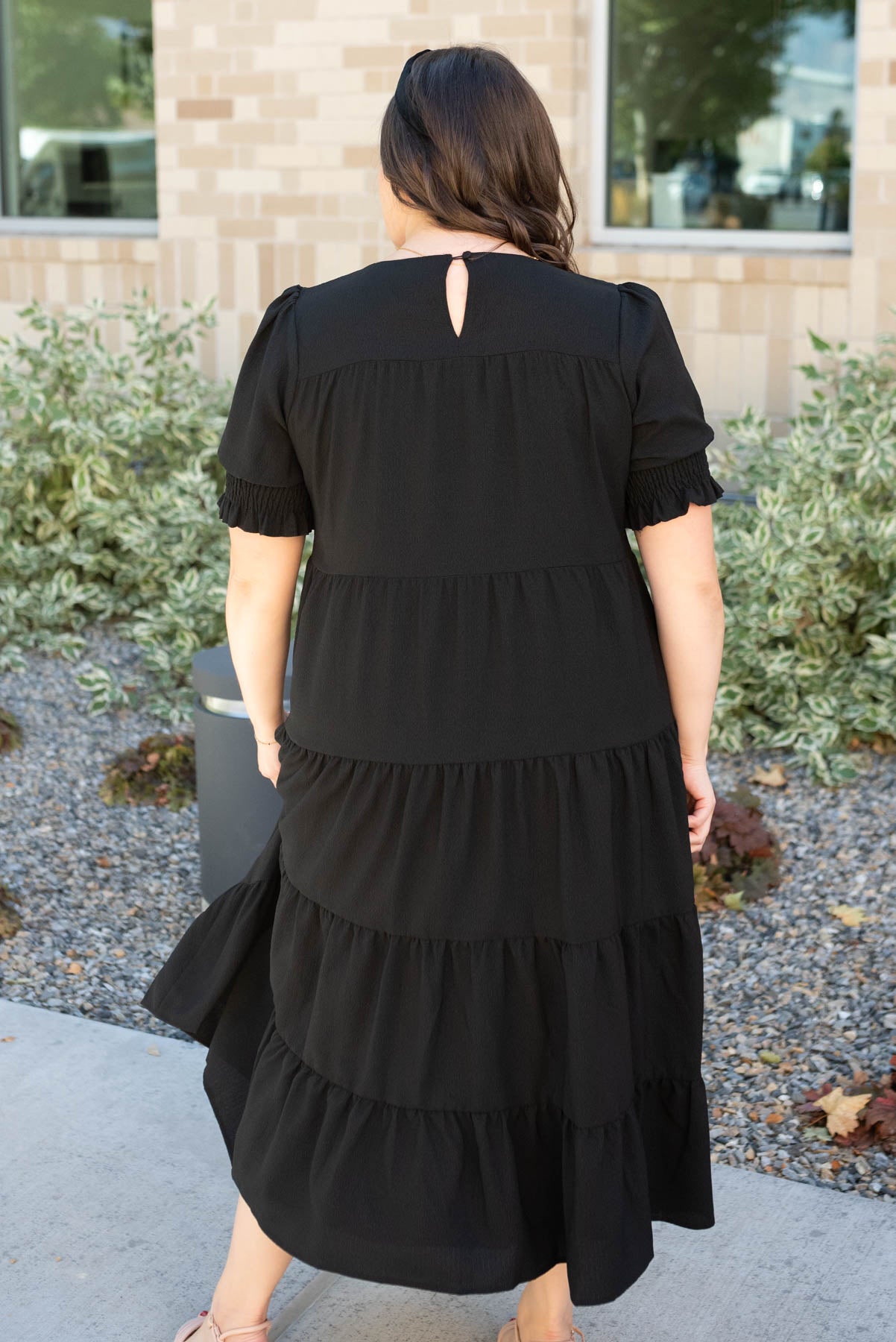 Back view of the plus size tiered black dress