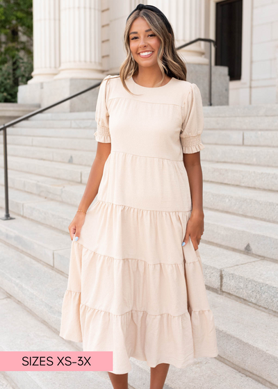 Tiered cream dress with elastic cuffs and small ruffle on the sleeve