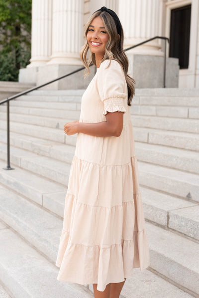 Side view of the tiered cream dress