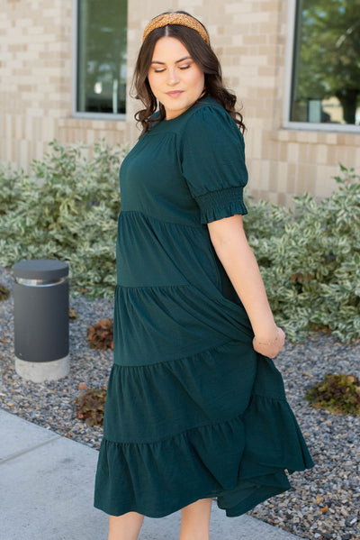 Side view of the plus size tiered dark green dress