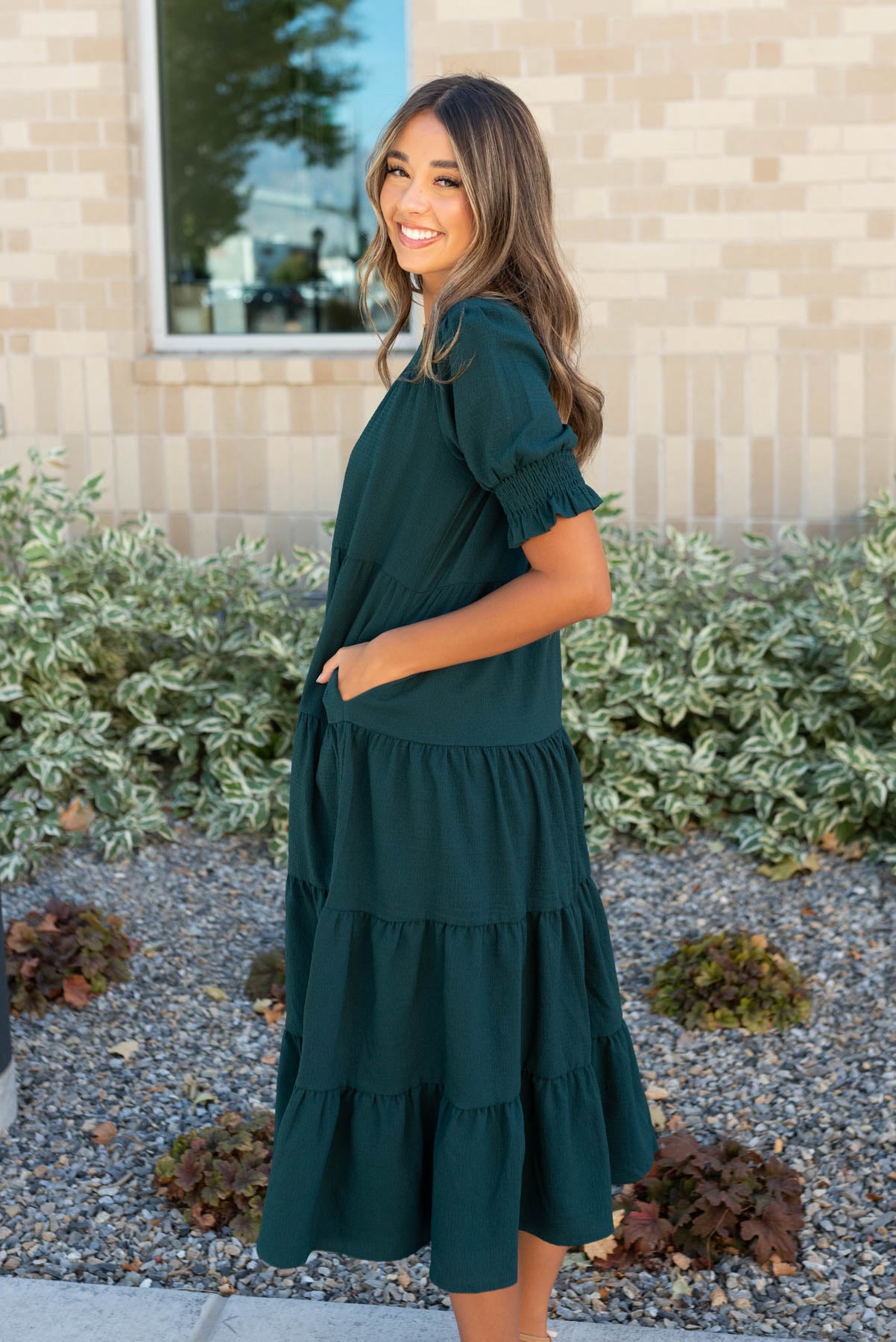 Side view of the tiered dark green dress