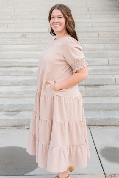 Side view of the tiered dusty blush dress in plus size