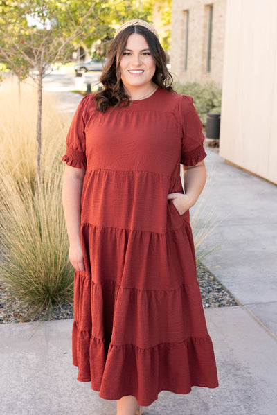 Plus size tiered rust dress with elastic cuff and pockets