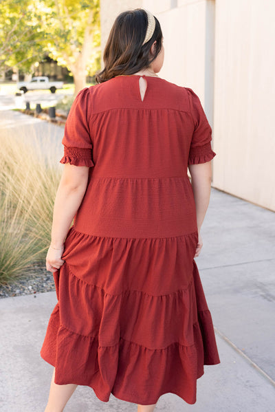 Back view of the plus size tiered rust dress