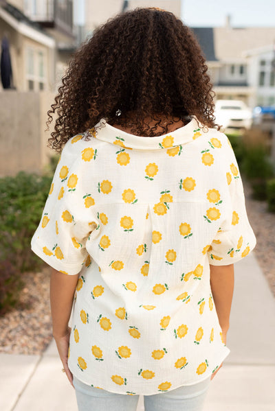 Back view of the ivory gold floral top