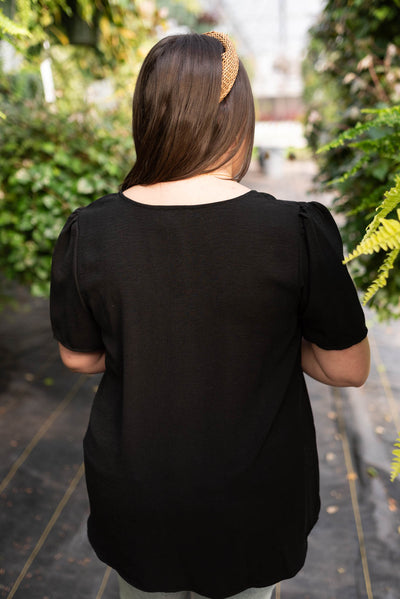 Back view of a plus size black top