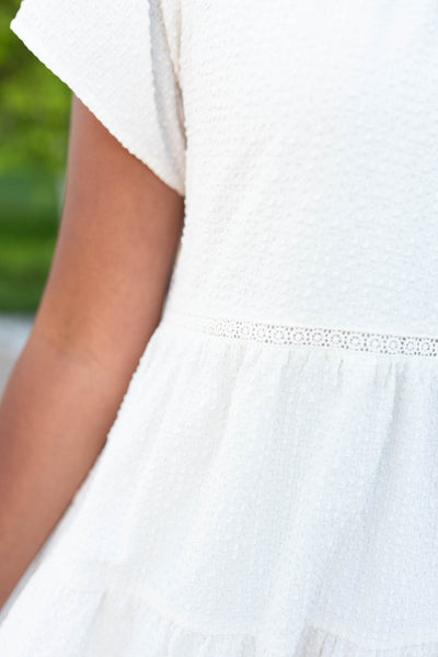Ivory tiered dress with lace detail at the waist